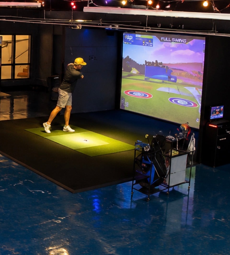 Guest playing golf on the Putter Up simulator